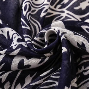 Macro view of navy paisley cotton scarf showing soft texture and fringe details