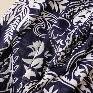Detail of dark blue and white paisley print on breathable cotton-linen textured fabric
