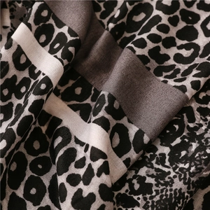 Close-up of leopard print cotton linen fabric showing fine texture and draped folds