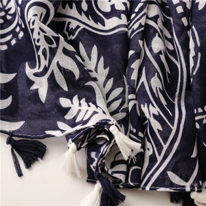 Detail of navy paisley cotton linen scarf featuring hand-knotted tassel fringe texture