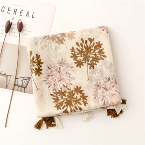 Detail of floral printed linen scarf with elegant tassels and natural fiber texture