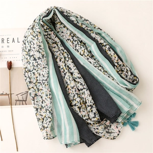 Flat lay of green leopard floral cotton linen scarf with tassels and pattern patchwork