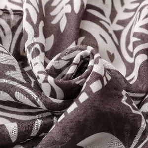 Macro shot of cotton linen scarf with chocolate brown leaf print and detailed fabric texture