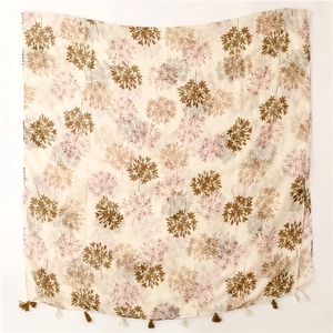 Close-up of floral print linen scarf featuring vintage patterns and tassel edge detail