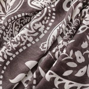 Close-up of lightweight navy paisley scarf fabric with intricate patterns and texture
