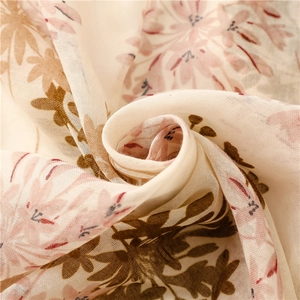 Detailed close-up of floral print on breathable cotton-linen feel scarf with tassels