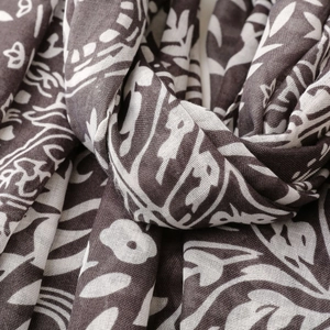 Detailed close-up of brown floral paisley patterns on lightweight breathable cotton scarf