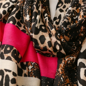 Detail of leopard print and pink patchwork scarf showing soft fabric texture and drape