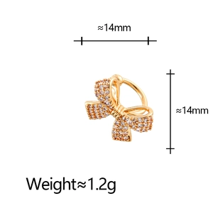 Macro view of golden bow ear cuff with micro-pave zircons and 14mm size measurement