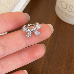 Silver bow ear cuff for women featuring sparkling zircons and a non-piercing design