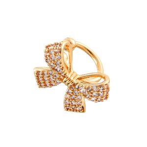 Chic gold bow ear cuff with pavé cubic zirconia accents on a minimalist white background