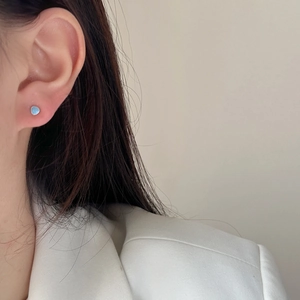 Minimalist light blue heart stud earrings for women shown on model for elegant daily wear