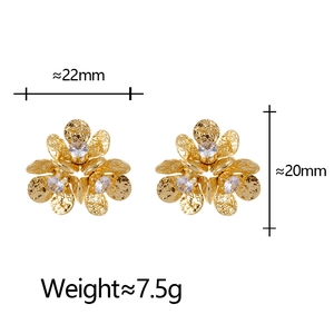 Elegant gold flower stud earrings with sparkling cubic zirconia and hammered texture