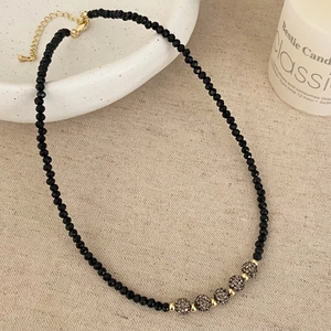 Close-up of black spinel beaded necklace with five micro-set zircon pave ball beads