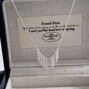 Minimalist silver fringe tassel necklace displayed in a premium jewelry box