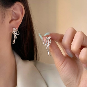 Elegant ribbon-shaped silver earrings with pearl accents and minimalist fluid design