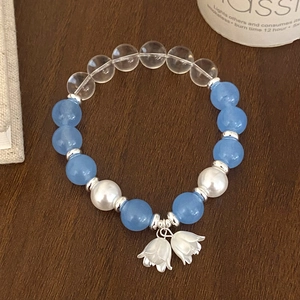 Minimalist light blue natural stone beaded bracelet with white lily of the valley charms