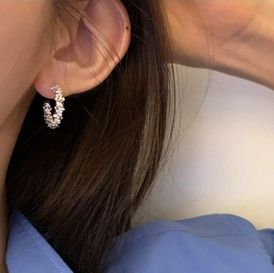 Minimalist silver C-shape earrings with micro-inlaid rhinestones on model side view
