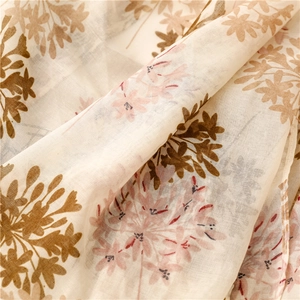 Close-up of floral cotton linen scarf with soft folds and elegant botanical patterns