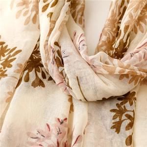 Close-up of lightweight floral scarf showing vintage leaf patterns and fabric texture