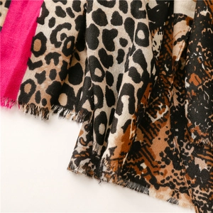 Detail of leopard print cotton linen scarf with pink patch and fringe trim edges