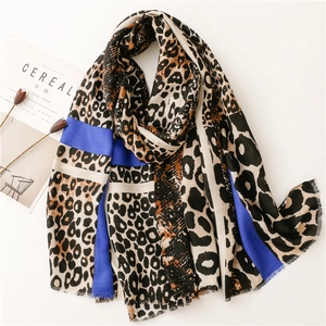 Detail of leopard print scarf with navy blue panels and soft frayed fringe edges