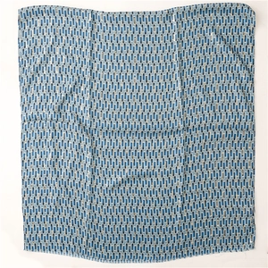 Detail of blue geometric silk scarf with soft fringe edges and linen texture