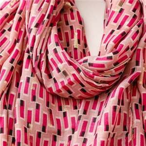 Detail of pink cotton scarf with gold foil geometric pattern and soft fringe edges