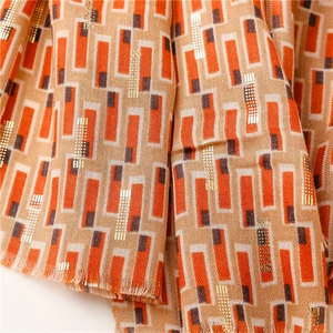 Detail of cotton-linen feel scarf with geometric gold foil print and fringe edges