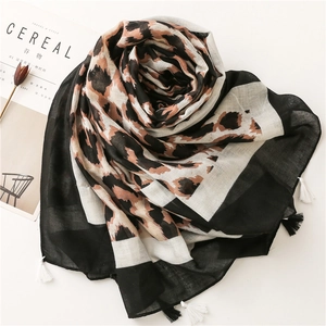 Detail of leopard print cotton linen scarf with black fringe tassels and border