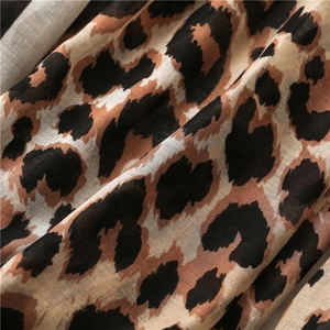 Macro view of leopard print cotton linen fabric with high-density texture and soft folds