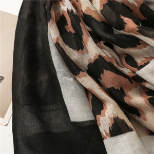 Close-up of leopard print cotton linen scarf showing translucent texture and soft fringe