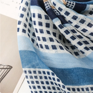 Macro detail of geometric patterned cotton linen scarf with soft woven textile texture