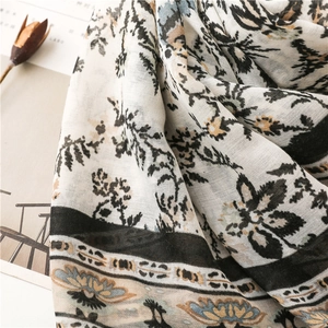 Close-up of floral cotton-linen scarf with vintage print and soft woven texture
