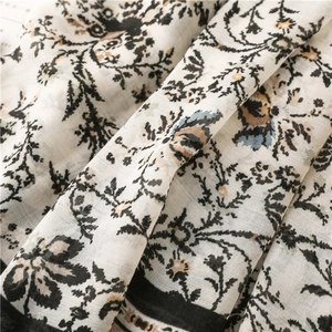 Close-up of soft floral cotton scarf with vintage botanical patterns and black borders