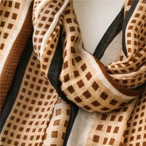 Detailed macro view of the soft geometric pattern and fine texture of the cotton linen scarf