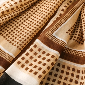 Detailed close-up of retro geometric checked pattern cotton linen scarf with fine textures