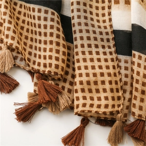 Detailed macro view of the cotton linen scarf showing geometric patterns and fringe tassels