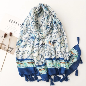 Floral print cotton linen scarf with blue foliage pattern and bohemian tassels