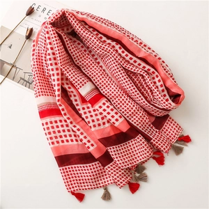 Detail of red and white plaid cotton linen scarf with handmade tassel edges