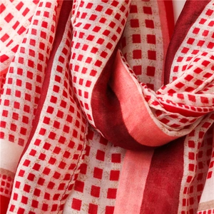 Detail shot of the red and white geometric square pattern and soft cotton linen texture