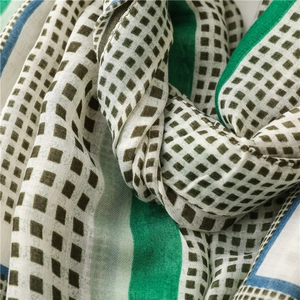 Close-up of geometric cotton linen scarf showing soft fabric texture and stitched edges