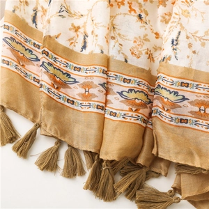 Detailed view of floral cotton linen scarf featuring bohemian patterns and tassels