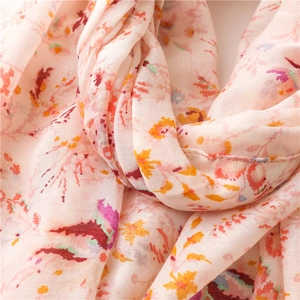 Close-up of soft floral pattern on lightweight cotton linen scarf with fine stitching