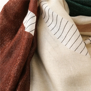 Macro detail of geometric color block shawl with silver lurex thread and textured waves