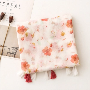 Detail of pink floral cotton scarf with fringe tassels and cherry blossom print