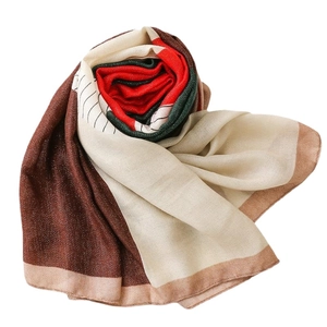Elegant cotton linen scarf with red green stripes folded into a creative rose shape