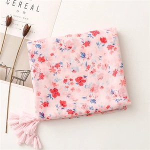 Pink floral cotton scarf with red and blue flower patterns and elegant tassel detail