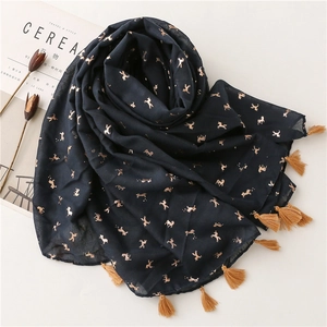 Detail of dark blue scarf with gold horse print and matching tassels on white background