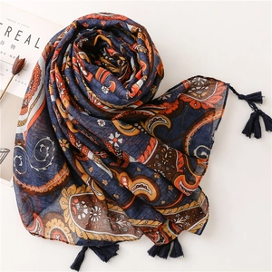 Detail of dark blue paisley scarf with tassels and breathable cotton-linen texture